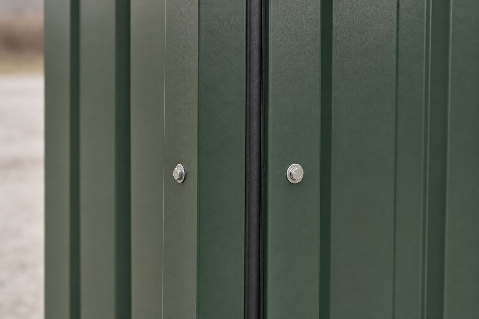 Close-up of hunter green TEMLOC 18-gauge steel wall panels with bolted vertical joint